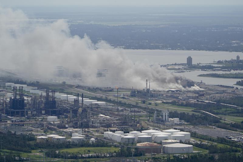 FILE - A chemical fire burns at a facility during the aftermath of Hurricane Laura, Aug. 27, 2020, near Lake Charles, La. The Securities and Exchange Commission moved closer Friday, June 17, 2022, to a final rule that would dramatically change what public companies tell shareholders about climate change. Companies would also have to disclose risks related to the physical impact of storms, drought and higher temperatures brought on by global warming. (AP Photo/David J. Phillip, File)