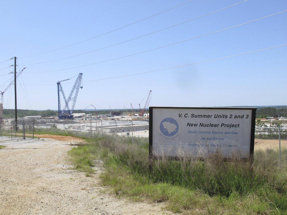 FILE - Construction is well underway for two new nuclear reactors at the V.C. Summer Nuclear Station in Jenkinsville, S.C. on Monday, April 9, 2012. A South Carolina judge has approved a second round of refunds for customers of a utility that poured billions of dollars into two nuclear power plants that never produced a watt of power. About $61 million is being set aside for Dominion Energy South Carolina after the utility sold a number of properties as part of the settlement of a class-action lawsuit by 1.1 million of its customers over the never completed plants at the V.C. Summer Nuclear Station near Columbia. (AP Photo/Jeffrey Collins, File)