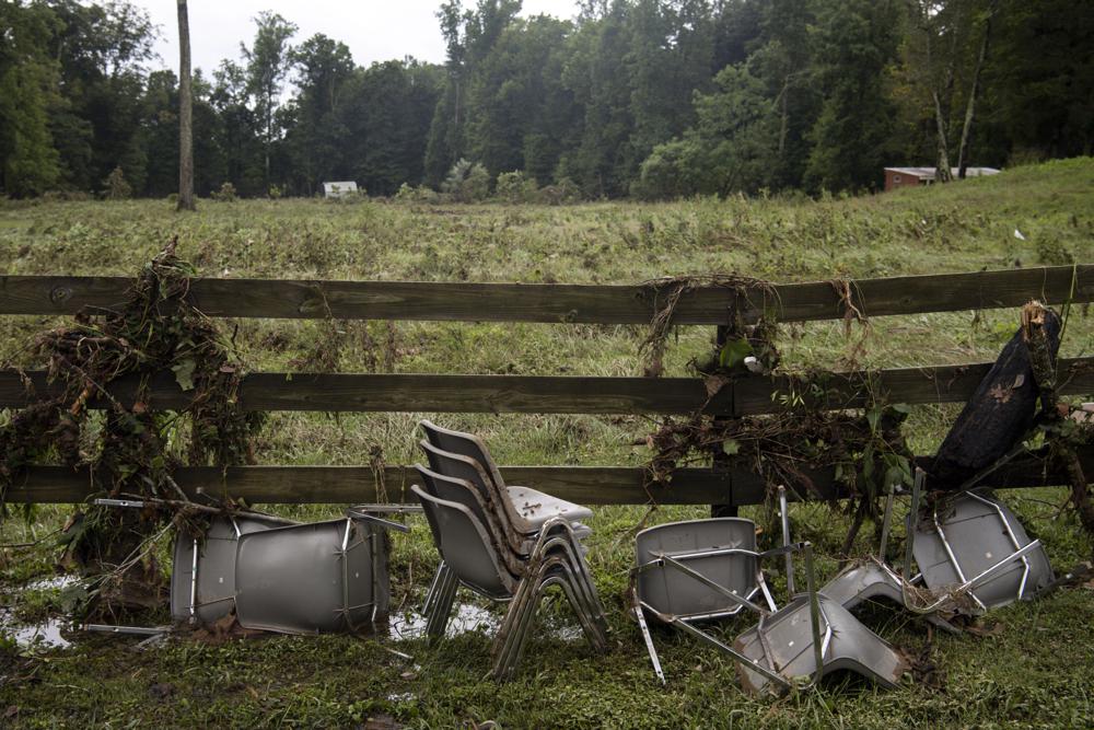 Chairs picked up by flood water are strewn along Sam Hollow Road following heavy rainfall on Saturday, Aug. 21, 2021, in Dickson, Tenn. (Josie Norris/The Tennessean via AP)