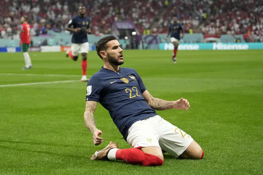France's Theo Hernandez, center, celebrates after scoring the opening goal during the World Cup semifinal soccer match between France and Morocco at the Al Bayt Stadium in Al Khor, Qatar, Wednesday, Dec. 14, 2022. (AP Photo/Christophe Ena)