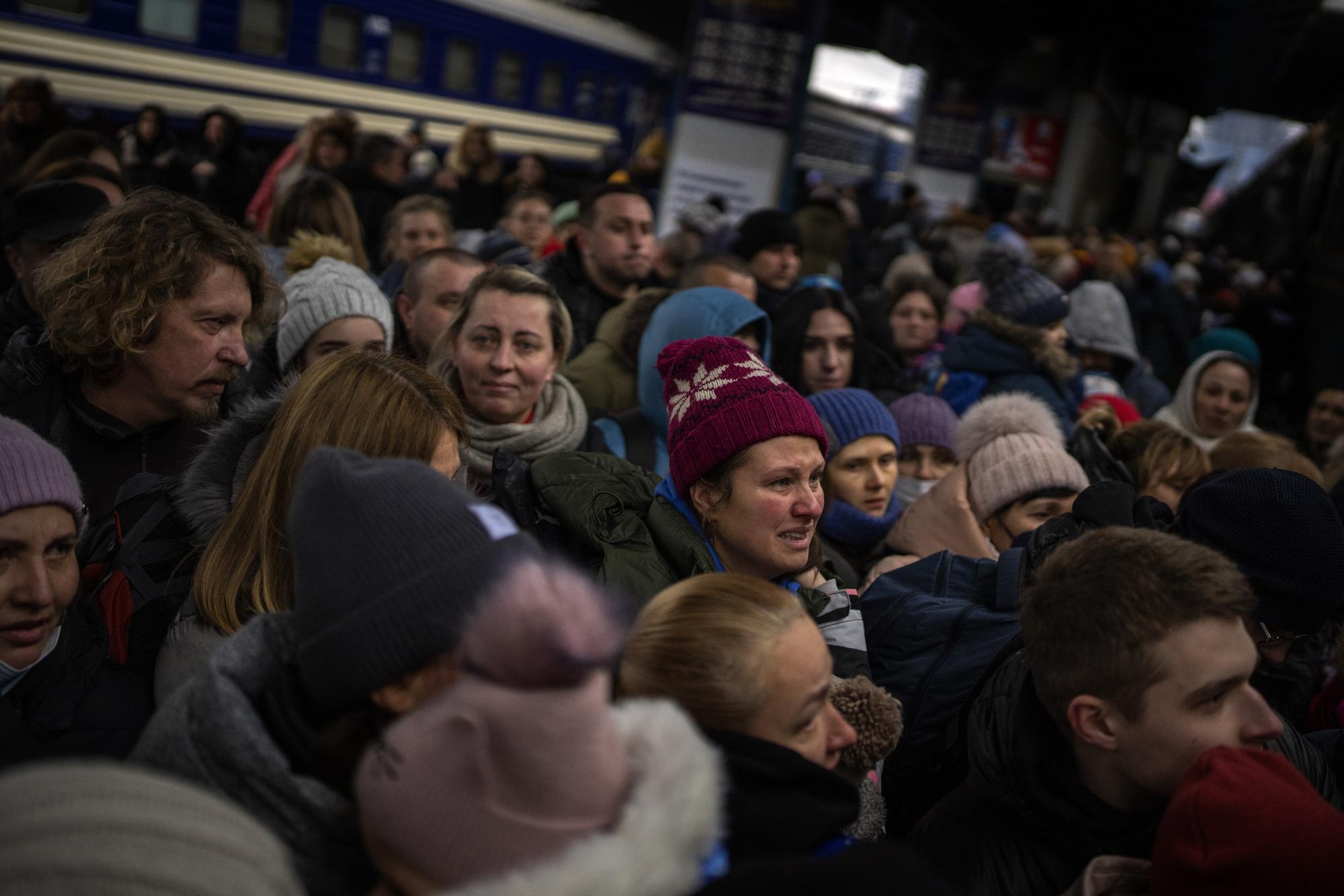 Women and children try to get onto a train bound for Lviv, at the Kyiv station in Ukraine, Thursday, March 3. 2022. (AP Photo/Emilio Morenatti)