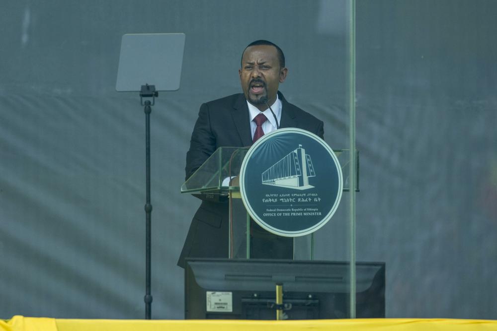 Ethiopia's Prime Minister Abiy Ahmed speaks behind bulletproof glass at his inauguration ceremony, after he was sworn in for a second five-year term, in the capital Addis Ababa, Ethiopia Monday, Oct. 4, 2021. Abiy was sworn in Monday for a second five-year term running a country in the grip of a nearly year-long war, as a handful of visiting African leaders urged him to hold the nation together. (AP Photo/Mulugeta Ayene)