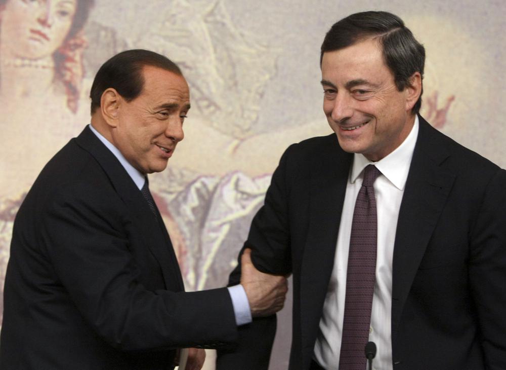 FILE - Former and present Italian Premiers Silvio Berlusconi, left, and Mario Draghi, right, are seen during a press conference at Chigi Palace,in Rome, on Oct. 8, 2008. Italy’s lower chamber of parliament on Tuesday set Jan. 24 as the start date to begin voting for a new Italian president, officially kicking off a campaign that is expected to see Premier Mario Draghi and ex-Premier Silvio Berlusconi vie for the prestigious job. The victor, who is chosen by around 1,000 “big electors among lawmakers and regional representatives, will replace President Sergio Mattarella, whose seven-year term ends Feb. 3. The voting is expected to last several rounds over several days. (AP Photo/Sandro Pace)