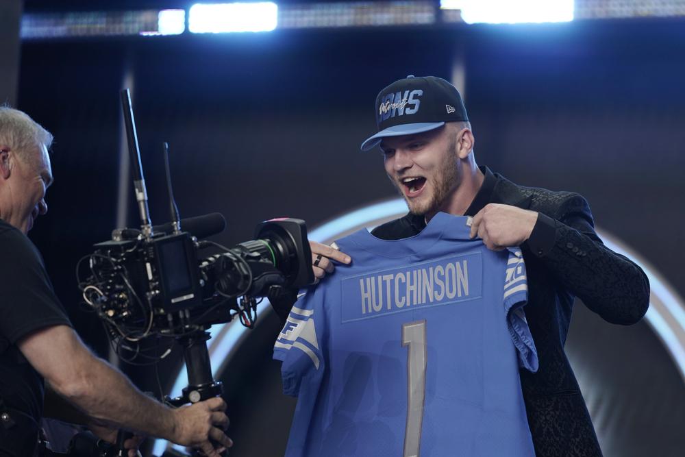 Michigan defensive end Aidan Hutchinson celebrates being selected by the Detroit Lions as the second pick in the NFL football draft Thursday, April 28, 2022, in Las Vegas. (AP Photo/John Locher )