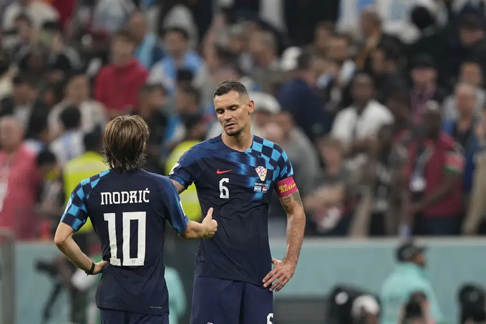 Croatia's Luka Modric, left, and Croatia's Dejan Lovren shake hands after the World Cup semifinal soccer match between Argentina and Croatia at the Lusail Stadium in Lusail, Qatar, Tuesday, Dec. 13, 2022. (AP Photo/Martin Meissner)