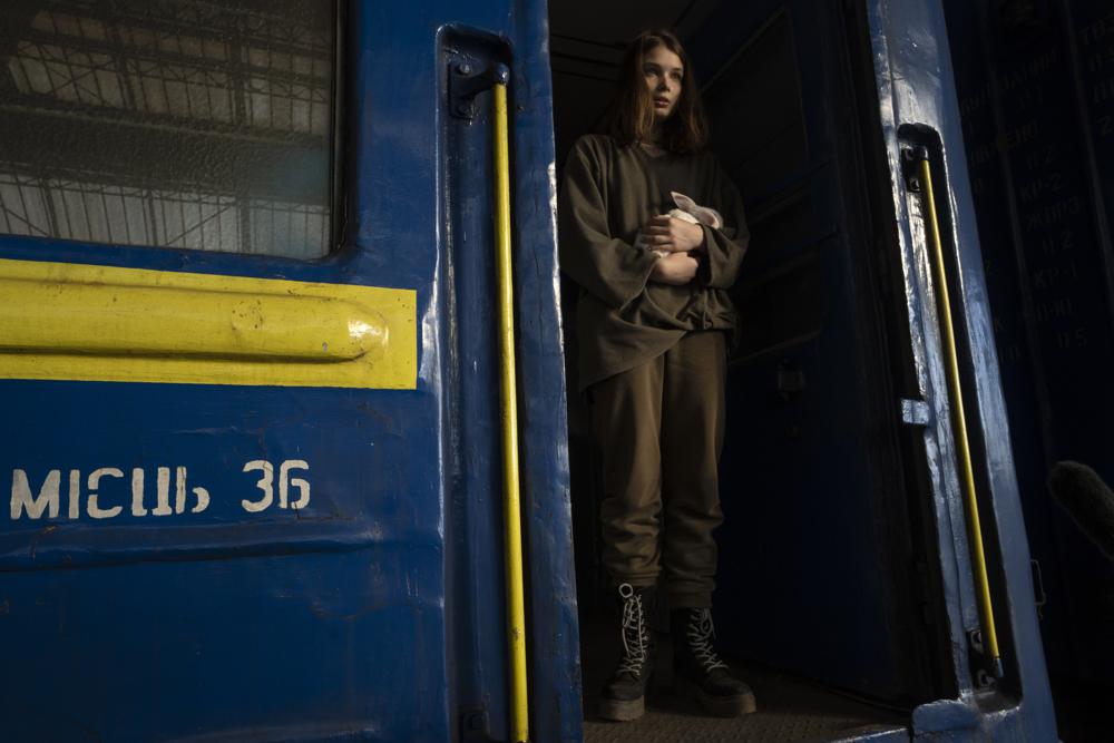 16-year-old Julia from Dnipro, who is traveling alone, holds her pet rabbit Baby after arriving to the Lviv main station, western Ukraine, Thursday, March 24, 2022. She was on her way to join her mother and then go on to Poland or Germany. (AP Photo/Nariman El-Mofty)