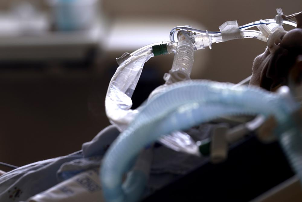 FILE - In this Aug. 17, 2021, file photo, patient with COVID-19 on breathing support lies in a bed in an intensive care unit at the Willis-Knighton Medical Center in Shreveport, La. The summer that was supposed to mark America’s independence from COVID-19 is instead drawing to a close with the U.S. more firmly under the tyranny of the virus, with deaths per day back up to where they were in March 2021. (AP Photo/Gerald Herbert, File)