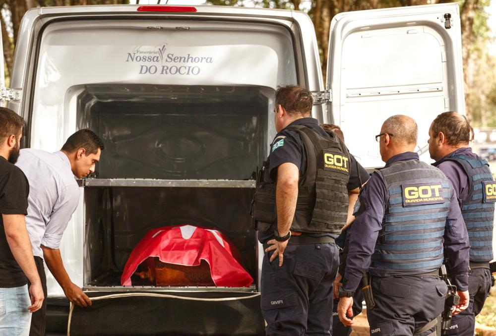 The coffin of Marcelo Arruda, a local official from the leftist Workers' Party, arrives to the Jardim Sao Paulo cemetery in Foz do Iguacu, Parana state, Brazil, Monday, July 11, 2022. Federal prison guard Jorge Jose da Rocha killed Arruda in the Brazilian state of Parana, according to state police. (AP Photo/Alexander Moschkowich)