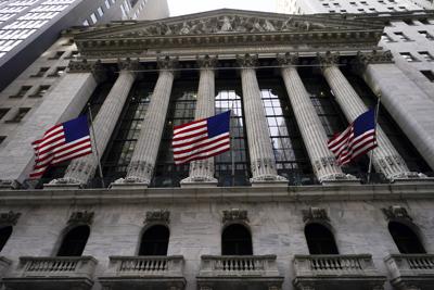 FILE - American flags fly outside the New York Stock exchange, Friday, Jan. 14, 2022, in the Financial District in New York. Stocks are off to a weak start on Wall Street, Thursday, Feb. 17, chipping away at the weekly gains for major indexes.  (AP Photo/Mary Altaffer, File)