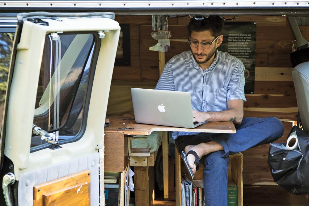 FILE - U.S. journalist Danny Fenster works out of his van that he made into a home/office in Detroit in 2018. The lawyer for detained U.S. journalist Danny Fenster says a court in military-ruled Myanmar on Friday, Nov. 12, 2021 has sentenced him to 11 years in prison after finding him guilty on several charges including incitement for allegedly spreading false or inflammatory information. (Fenster Family photo via AP, File)