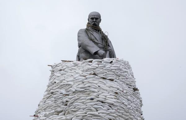 A monument of Taras Shevchenko, a Ukrainian poet and a national symbol, is covered with bags to protect it from Russian shelling in Kharkiv, Ukraine, Sunday, March 27, 2022. The bronze, 16-meter high monument was placed in 1935, survived WWII and is considered one of the world's best monuments to Shevchenko. (AP Photo/Efrem Lukatsky)