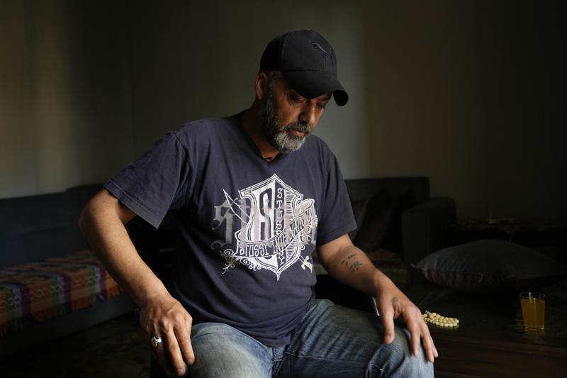 Bilal Dandashi, gestures as he speaks during an interview with the Associated Press, in Tripoli, Lebanon, Wednesday, April 27, 2022. A week ago, the boat carrying Bilal Dandashi, his relatives and dozens of others hoping to escape Lebanon and reach Europe sank in the Mediterranean. Dandashi still doesn't know if his wife and children are alive or dead. (AP Photo/Hassan Ammar)