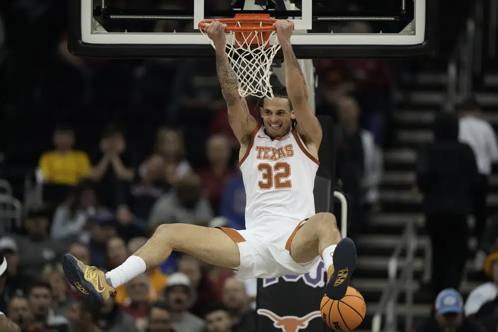 Texas forward Christian Bishop after dunking the ball during the first half of an NCAA college basketball game against TCU in the semifinal round of the Big 12 Conference tournament Friday, March 10, 2023, in Kansas City, Mo. (AP Photo/Charlie Riedel)