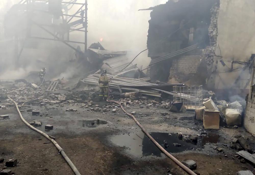 In this photo released by Russian Emergency Ministry Press Service, emergency personnel work at the site of an explosion and fire at a gunpowder factory in the Ryazan region, about 270 kilometers (about 167 miles) southeast of Moscow, Russia, Friday, Oct. 22, 2021. Russian emergency officials say that at least seven people have died and a further nine are missing following an explosion and fire at a gunpowder factory.  (Ministry of Emergency Situations press service via AP)