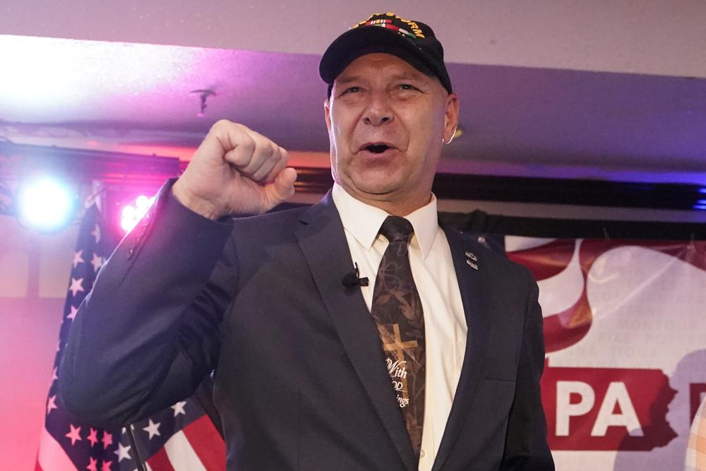 FILE - State Sen. Doug Mastriano, R-Franklin, the Republican candidate for Governor of Pennsylvania, gestures to the cheering crowd during his primary night election party in Chambersburg, Pa., May 17, 2022. (AP Photo/Carolyn Kaster, File)