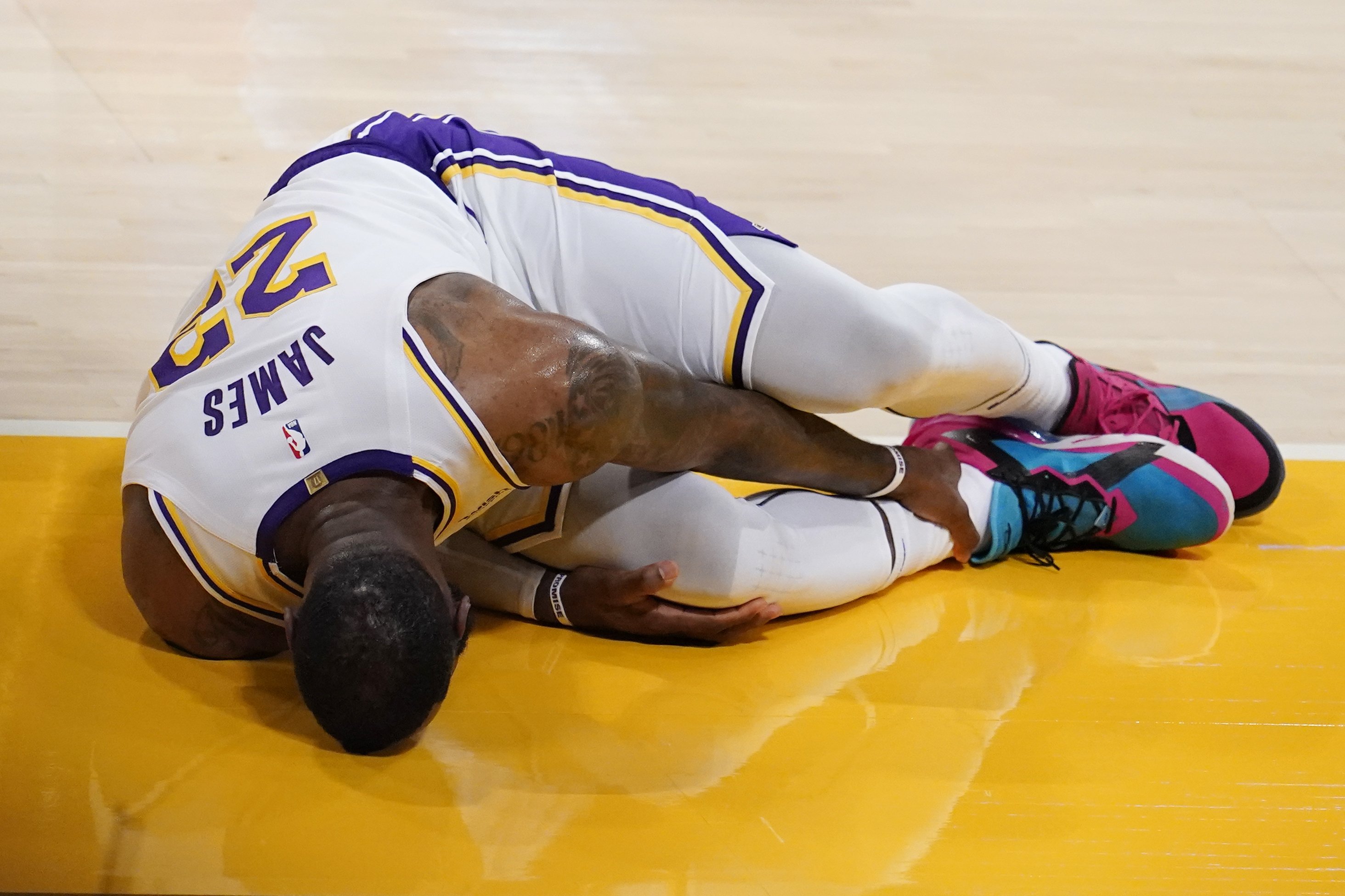 LeBron James leaves court with a right ankle injury against the Falcons