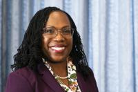 Supreme Court nominee Judge Ketanji Brown Jackson glances at members of the media during her meeting with Sen Mark Warner, D-Va., on Capitol Hill, Monday, April 4, 2022, in Washington. (AP Photo/Manuel Balce Ceneta)
