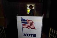 FILE - A person waits in line to vote in the Georgia's primary election on May 24, 2022, in Atlanta. A new poll shows 71% of voters think the future of the country is at stake when they vote in November's midterm elections. That's according to a new poll from The Associated Press-NORC Center for Public Affairs Research. (AP Photo/Brynn Anderson, File)