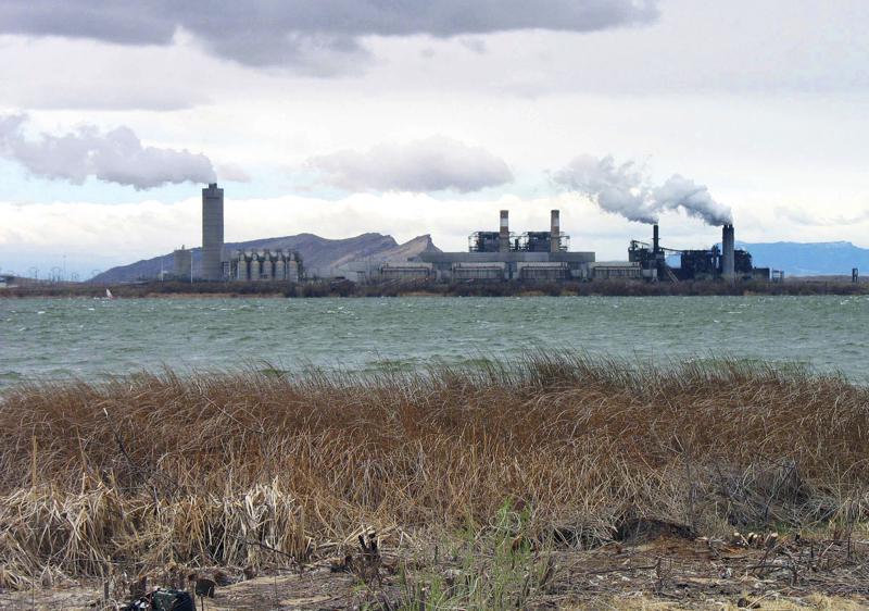 FILE - In this April 2006, file photo, is the Four Corners Power Plant in Waterflow, N.M., near the San Juan River in northwestern New Mexico. New Mexico's largest electric utility wants to abandon its interest in a coal-fired power plant that serves customers around the southwestern U.S. as it looks to merge with global energy giant Iberdrola. State regulators took public comments Monday, Aug. 30, 2021, about plans by Public Service Corp. of New Mexico to transfer its share of the Four Corners Power Plant to an energy company backed by the Navajo Nation. (AP Photo/Susan Montoya Bryan, File)