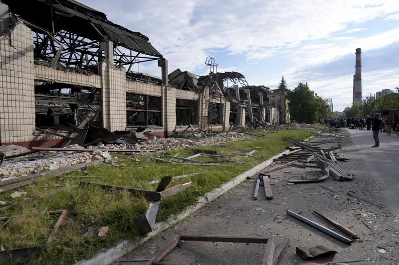 Wreckage lie along a street at a railway service facility hit by a Russian missile strike in Kyiv, Ukraine, Sunday, June 5, 2022. (AP Photo/Natacha Pisarenko)