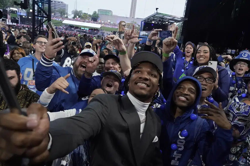 Florida quarterback Anthony Richardson takes a selfie with fans after being chosen by the Indianapolis Colts with the fourth overall pick during the first round of the NFL football draft, Thursday, April 27, 2023, in Kansas City, Mo. (AP Photo/Charlie Riedel)