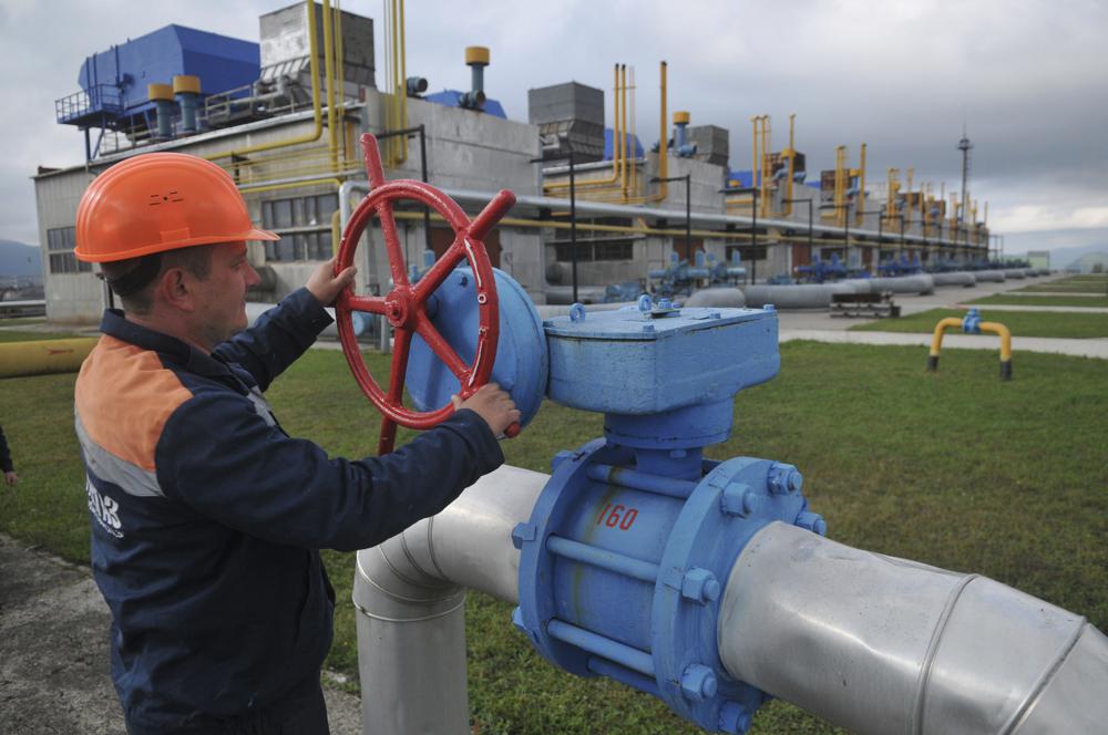 FILE - A worker at a Ukrainian gas station Volovets in western Ukraine Wednesday, in Oct. 7, 2015. Fears are rising about what would happen to Europe's energy supply if Russia were to invade Ukraine and then shut off its natural gas in retaliation for U.S. and European sanctions. The pipeline operators have told the European Union's executive commission that if there's a cold winter, the continent's gas companies will need to import more than they have in the past. (AP Photo/Pavlo Palamarchuk, File)