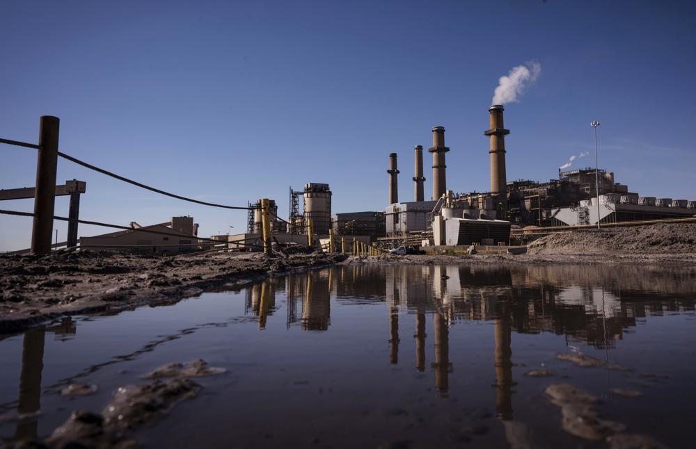 FILE - The San Juan Generating Station near Farmington, N.M., is shown Wednesday, Sept. 28, 2022. The New Mexico Supreme Court has cleared the way for the state's largest electric utility to delay issuing rate credits related to the recent closure of a coal-fired power plant. State regulators in June had ordered Public Service Co. of New Mexico to begin issuing the credits since customers would no longer benefit from the San Juan Generating Station after its closure. (Chancey Bush/The Albuquerque Journal via AP, File)