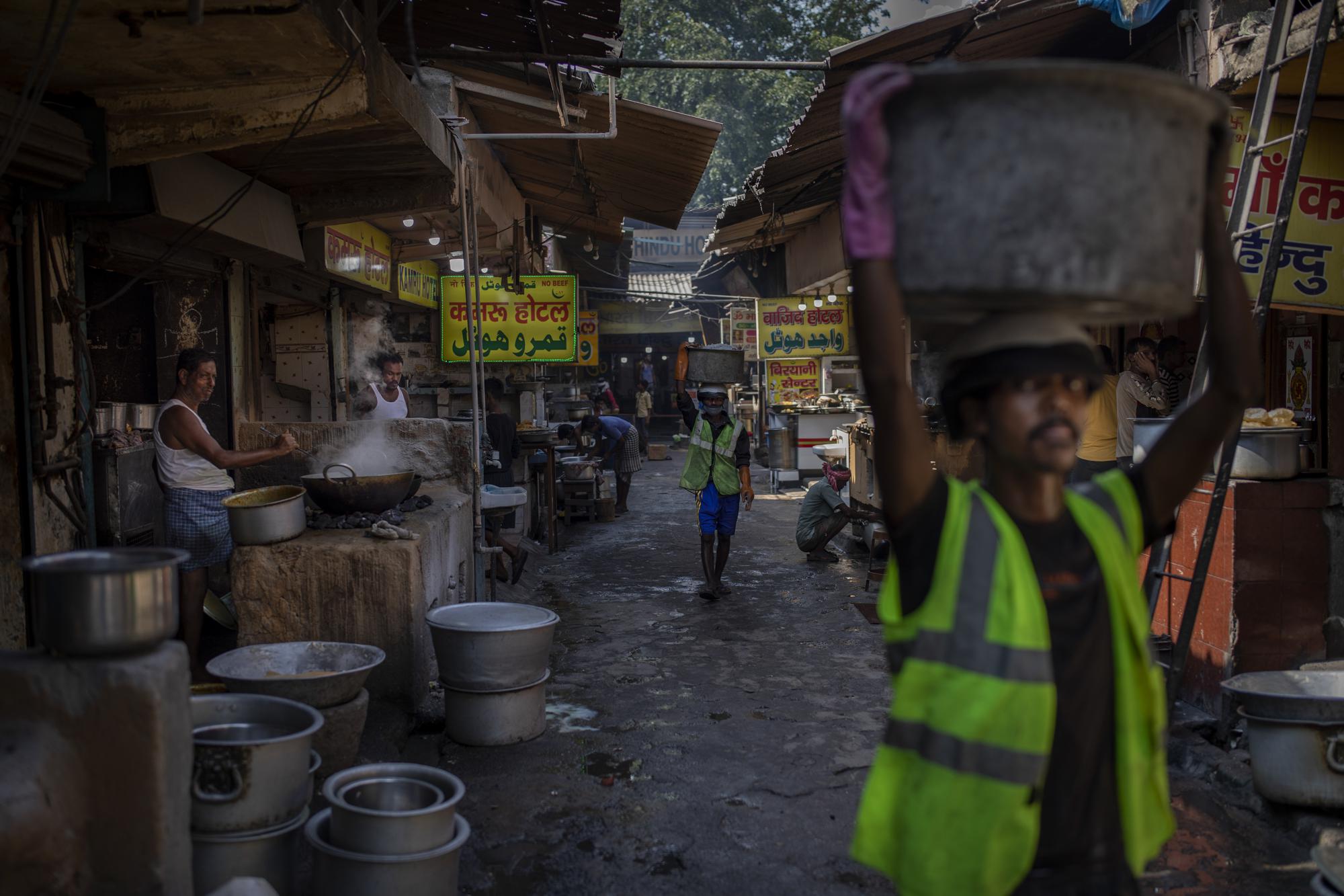 Restaurants along a food street use coal hearths in Dhanbad, an eastern Indian city in Jharkhand state, Saturday, Sept. 25, 2021. A 2021 Indian government study found that Jharkhand state -- among the poorest in India and the state with the nation’s largest coal reserves -- is also the most vulnerable Indian state to climate change. Efforts to fight climate change are being held back in part because coal, the biggest single source of climate-changing gases, provides cheap electricity and supports millions of jobs. It's one of the dilemmas facing world leaders gathered in Glasgow, Scotland this week in an attempt to stave off the worst effects of climate change. (AP Photo/Altaf Qadri)