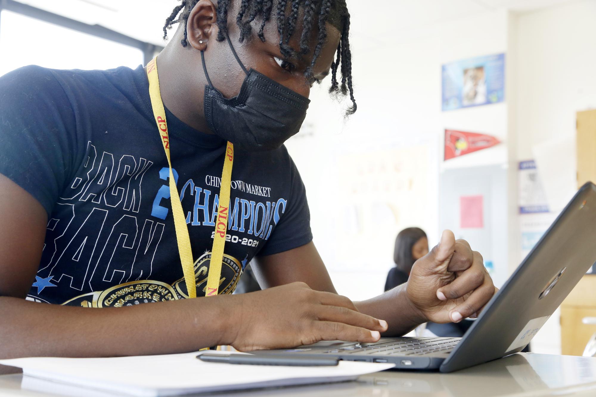 Freddie Golden, 17, works on a biology study guide at the Collins campus of North Lawndale College Prep High School in Chicago on Wednesday, June 2, 2021. Golden said online school was harder because he had trouble staying focused and motivated, but he said he still managed to keep his grades up. (AP Photo/Martha Irvine)