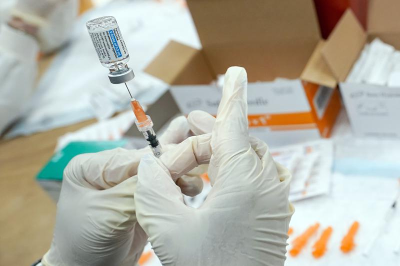 FILE - A registered nurse fills a syringe with the Johnson & Johnson COVID-19 vaccine at a pop-up vaccination site in the Staten Island borough of New York, April 8, 2021. All private employers in New York City will have to require their workers to get vaccinated against COVID-19, Mayor Bill de Blasio announced Monday, Dec. 6, imposing one of the most aggressive vaccine rules in the nation. (AP Photo/Mary Altaffer, File)
