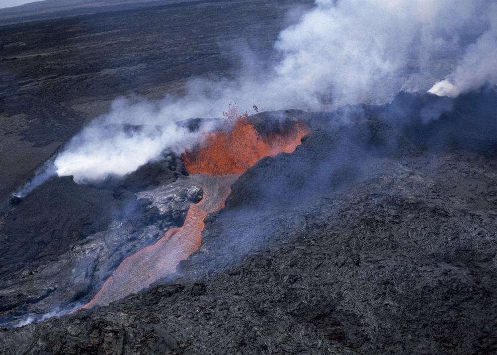 FILE - Molten rock flows from Mauna Loa, located on the south-central part of the island of Hawaii, on April 4, 1984. Hawaii officials are warning residents of the Big Island to prepare for the possibility that the world's largest active volcano may erupt given a recent spike in earthquakes at the summit of Mauna Loa. Scientists don't expect the volcano to erupt imminently, but officials are reminding people lava could reach some homes in just a few hours when it does. (AP Photo/File)