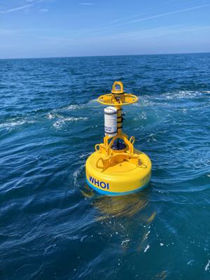 In this June 29, 2021, photo provided by Woods Hole Oceanographic Institution, an acoustic buoy floats in the water off the coast of Ocean City, Md. Acoustic buoys are equipped with technology developed at Woods Hole Oceanographic Institution, that can detect, classify, and report the sounds of marine animals in near real-time. Woods Hole is working with a French shipping company to deploy more of the buoys to protect rare North Atlantic right whales. (Mark Baugartner/Woods Hole Oceanographic Institution via AP)