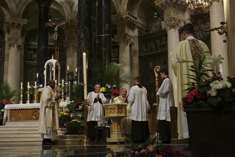 Archbishop Bernard Hebda blesses the baptismal water during the solemn Easter Vigil service at the Cathedral of St. Paul, in St. Paul, Minn., on Saturday, April 16, 2022. Hundreds of people attended the nearly three-hour-long Mass in the grand cathedral. (AP Photo/Giovanna Dell'Orto)