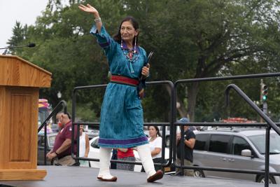FILE - Interior Secretary Deb Haaland waves after speaking to a crowd during a totem pole delivery ceremony by Native American tribal leaders and Indigenous activists, on Capitol Hill in Washington on July 29, 2021. Secretary Haaland vowed on her first day on the job to ensure Native American tribes have opportunities to speak with her and the agencies she oversees. Native American and Alaska Native groups are seeing change under Haaland but some remain frustrated with the pace of action. (AP Photo/Jose Luis Magana, File)
