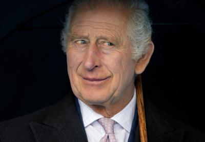 FILE - Britain's King Charles III smiles during a boat trip, in Hamburg, Germany, Friday, March 31, 2023. King Charles III arrived Wednesday for a three-day official visit to Germany. Britain's royal family turns the page on a new chapter with the coronation of King Charles III. Charles ascended the throne when his mother, Queen Elizabeth II, died last year. But the coronation Saturday is a religious ceremony that provides a more formal confirmation of his role as head of state and titular head of the Church of England. (AP Photo/Matthias Schrader, Pool, File)