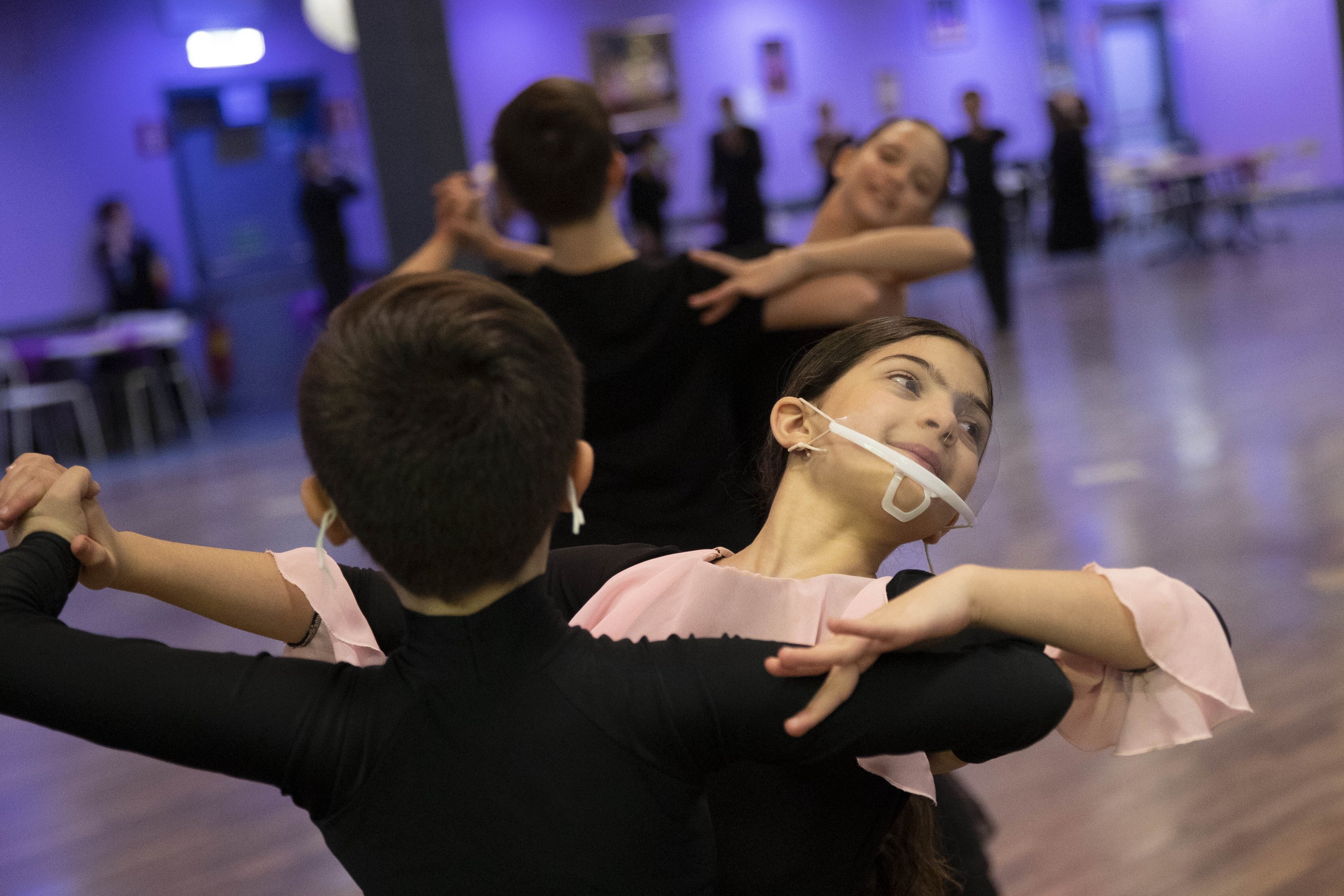 Ballroom dancers from Italy twirl in the blockade