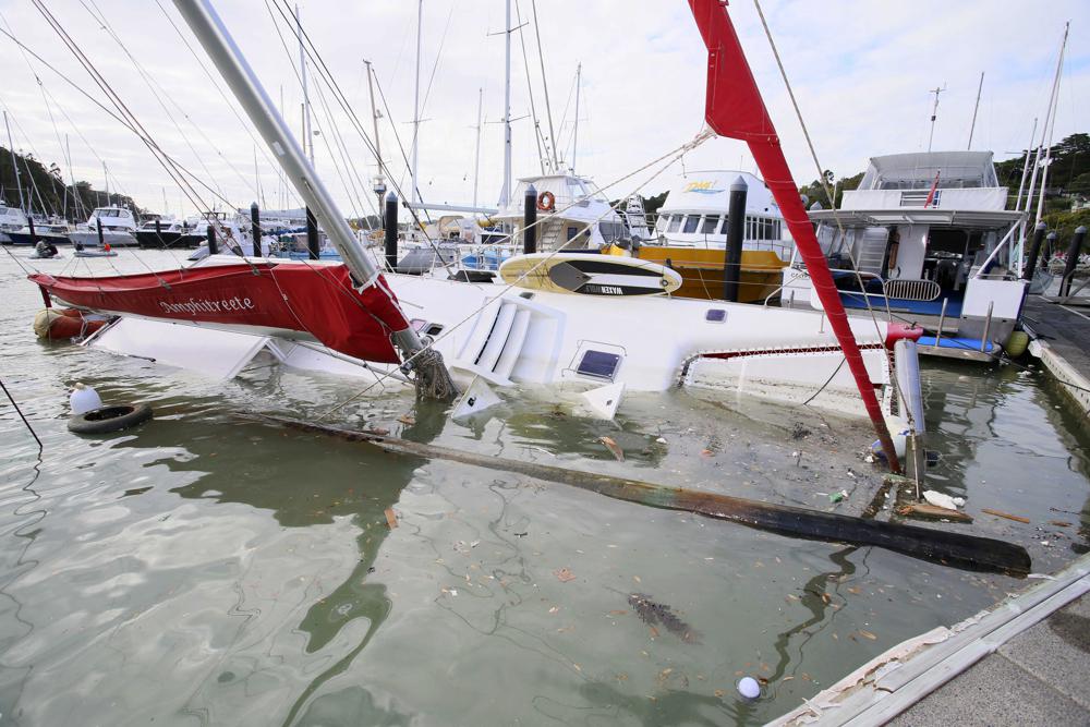 Un bote dañado está parcialmente sumergido en un puerto deportivo en Tutukaka, Nueva Zelanda, el domingo 16 de enero de 2022, luego de que las olas de la erupción de un volcán arrasaran el puerto deportivo.  Un volcán submarino entró en erupción de manera espectacular el sábado cerca de la nación de Tonga, en el Pacífico, y envió olas de tsunami que rompieron en la costa y la gente se precipitó hacia tierras más altas.  (Tanya White/Northern Advcate/NZME vía AP)