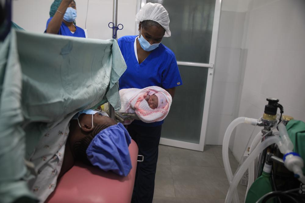 A nurse shows a mother her newborn baby after delivery at the Fontaine Hospital Center in the Cité Soleil area of Port-au-Prince, Haiti, Monday, Jan. 23, 2023. As gangs tighten their grip on Haiti, many medical facilities in the Caribbean nation's most violent areas have closed, leaving Fontaine as one of the last hospitals and social institutions in one of the world's most lawless places. (AP Photo/Odelyn Joseph)