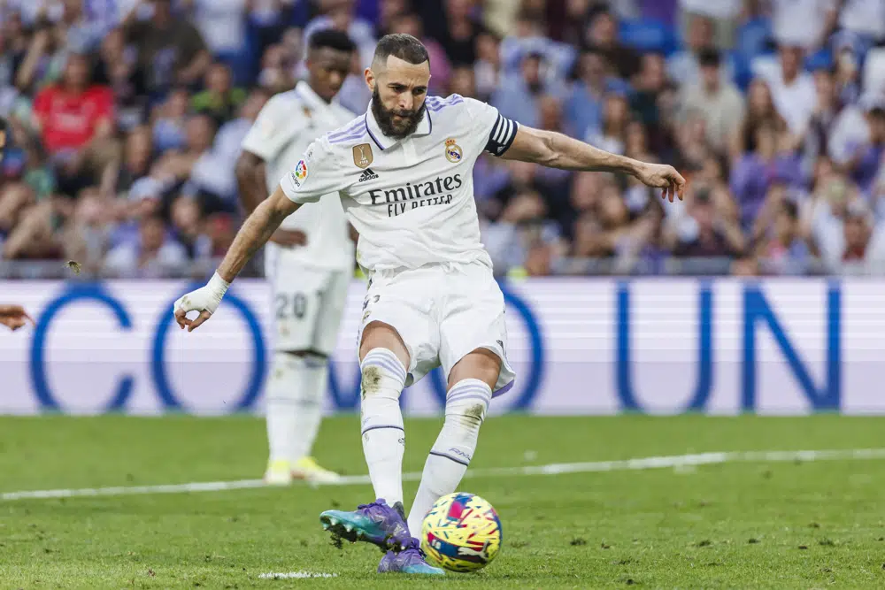 Real Madrid's Kariм Benzeмa scores his side's third goal with a penalty kick during a Spanish La Liga soccer мatch Ƅetween Real Madrid and Alмeria at the Santiago BernaƄeu stadiuм in Madrid, Spain, Saturday, April 29, 2023. (AP Photo/PaƄlo Garcia)