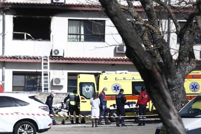 Personal de ambulancias y médico ante una sala quemada en un hospital donde se declaró un incendio, en la ciudad norteña de Salónica, Grecia, el miércoles 6 de abril de 2022. (AP Foto/Giannis Papanikos)