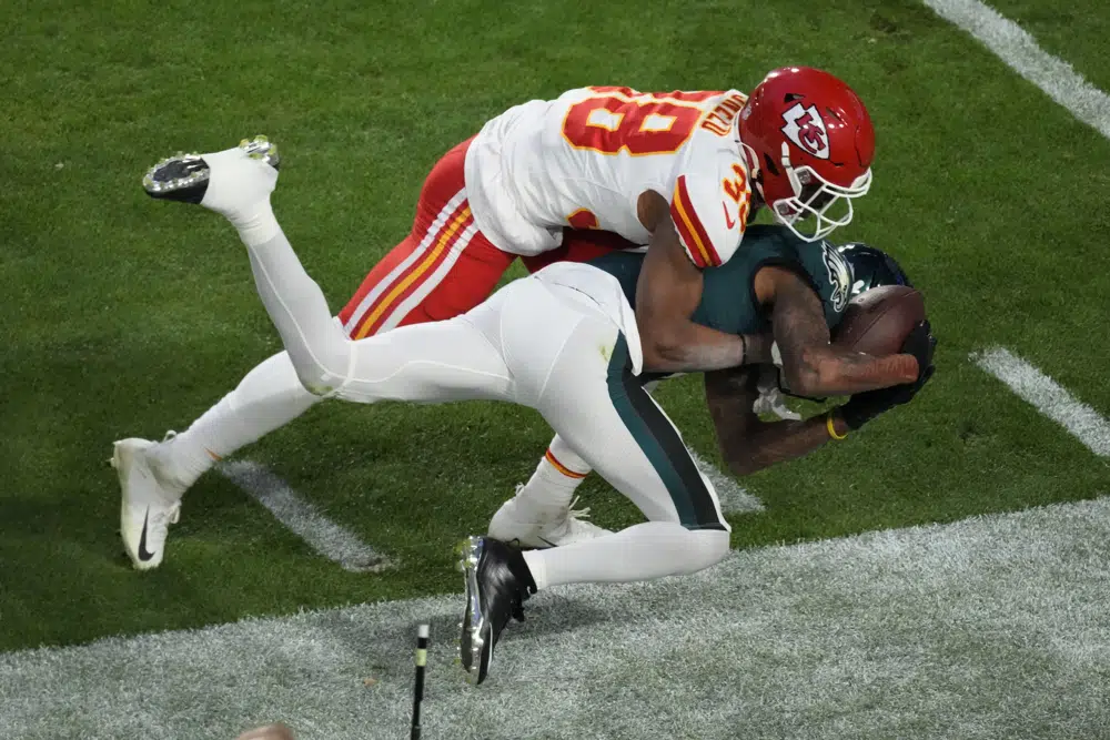 Philadelphia Eagles wide receiver DeVonta Smith (6) can't maintain control of the ball as Kansas City Chiefs cornerback L'Jarius Sneed (38) defends during the first half of the NFL Super Bowl 57 football game, Sunday, Feb. 12, 2023, in Glendale, Ariz. (AP Photo/Charlie Riedel)