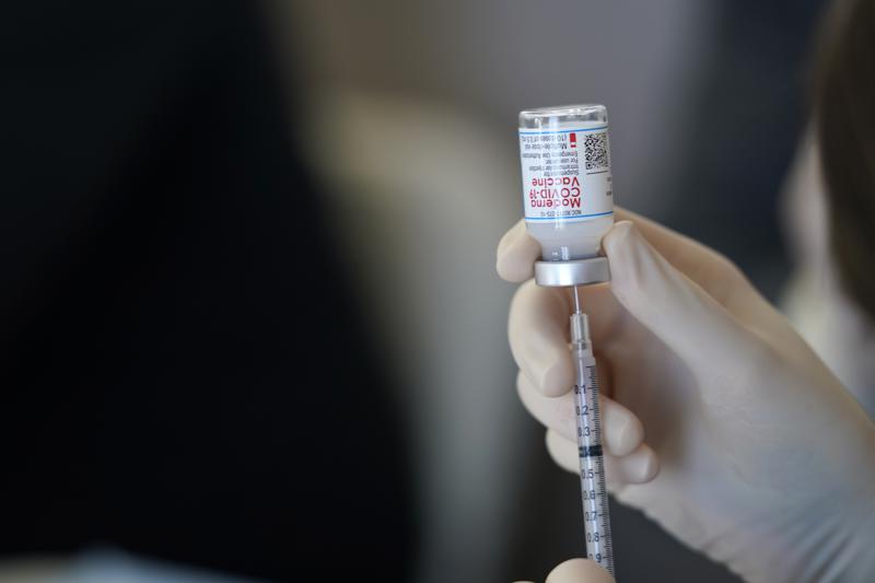 FILE - In this March 29, 2021 file photo, a worker readies syringes with the Moderna COVID-19 vaccine in Metairie, La. The Centers for Disease Control and Prevention is urging all pregnant women to get vaccinated against COVID-19, Wednesday, Aug. 11. The advice comes as hospitals in hot spots around the U.S. see disturbing numbers of unvaccinated mothers-to-be seriously ill with the virus. (AP Photo/Gerald Herbert, File)