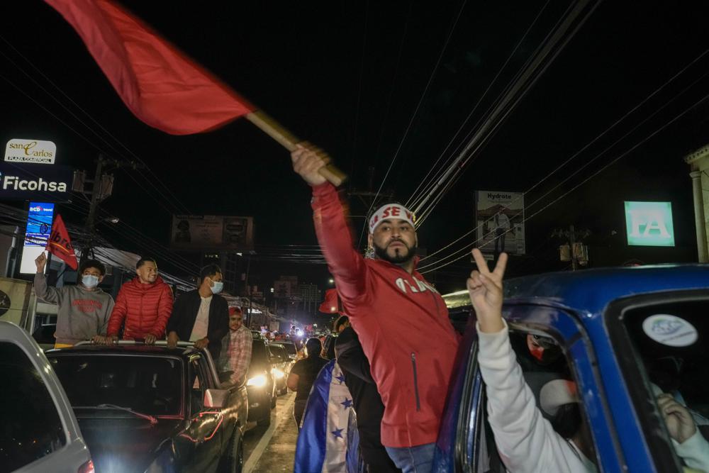 Free Party presidential candidate Xiomara Castro supporters celebrate after general elections, in Tegucigalpa, Honduras, Sunday, Nov. 28, 2021. Castro claimed victory, setting up a showdown with the National Party which said its candidate had won a vote that could end the conservative party's 12 years in power. (AP Photo/Moises Castillo)