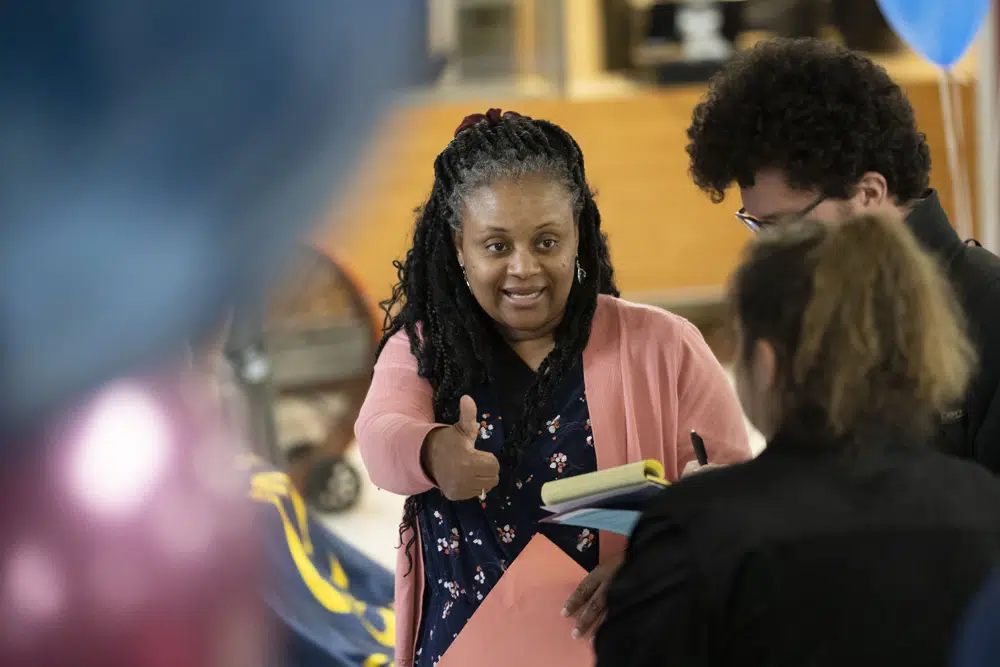 Learning Support Teacher Susannah Campbell speaks with prospective applicants during William Penn School District's teachers job fair at the high school's cafeteria in Lansdowne, Pa., Wednesday, May 3, 2023. As schools across the country struggle to find teachers to hire, more governors are pushing for pay increases and bonuses for the beleaguered profession. (AP Photo/Matt Rourke)