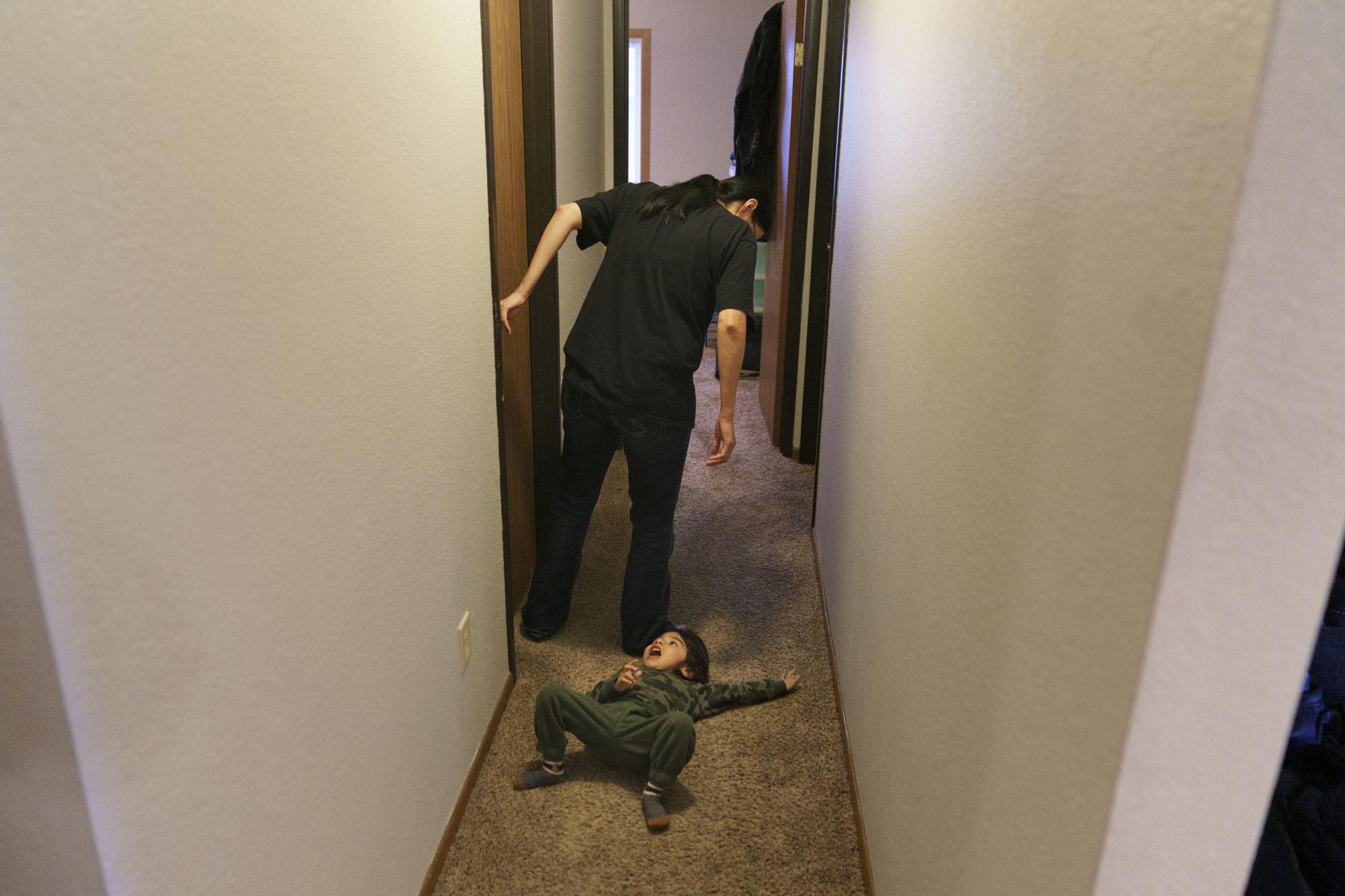 Georgianna Garbow-Warren talks to her son, Randy, 2, who has cerebral palsy, in their apartment in Moorhead, Minn., Wednesday, Nov. 17, 2021. Randy can't crawl yet, and scoots around on his back. "I blamed myself. I felt a lot of guilt and shame, a lot of pain," she said, about her son's medical difficulties. Then a doctor told her there was no way to know if it was from her drug use while pregnant or something else. She started to try to forgive herself, and just be present for him now. She takes him to therapy almost every day. (AP Photo/David Goldman)