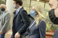 In this image take from video, Elizabeth Holmes leaves the United States Federal Courthouse, Friday, Nov. 19, 2021, in San Jose, Calif. The fallen Silicon Valley star, accused of bamboozling investors and patients into believing that her startup Theranos had developed a blood-testing device that would reshape health care, took the witness stand Friday in her trial for criminal fraud. (AP Photo/Mike Liedtke)