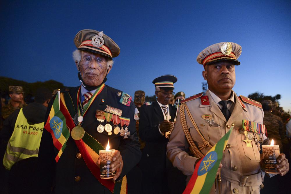 Current and former Ethiopian military personnel and the public commemorate federal soldiers killed by forces loyal to the Tigray People's Liberation Front (TPLF) at the start of the conflict one year ago, at a candlelit event outside the city administration in Addis Ababa, Ethiopia Wednesday, Nov. 3, 2021. All sides in Ethiopia's yearlong war in the Tigray region have committed abuses marked by extreme brutality that could amount to war crimes and crimes against humanity, the U.N. human rights chief said Wednesday. (AP Photo)