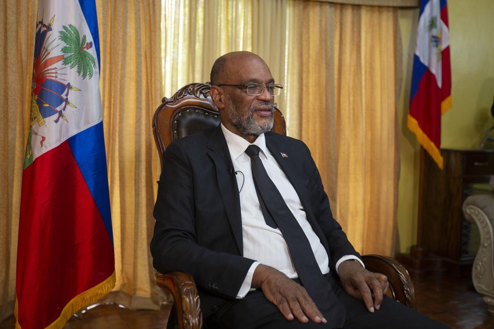 FILE - Haiti's Prime Minister Ariel Henry gives an interview at his private residence in Port-au-Prince, Sept. 28, 2021. Haiti welcomed the new year with violence as the prime minister fled the northern city of Gonaïves on Saturday, Jan. 1, 2022 following a shootout between his security forces and an armed group that had warned the leader not to set foot in the city. (AP Photo/Odelyn Joseph, File)