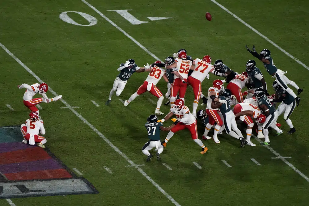 Kansas City Chiefs place kicker Harrison Butker (7) kicks the game-winning field goal as punter Tommy Townsend (5) holds during the second half of the NFL Super Bowl 57 football game against the Philadelphia Eagles, Sunday, Feb. 12, 2023, in Glendale, Ariz. (AP Photo/Charlie Riedel)