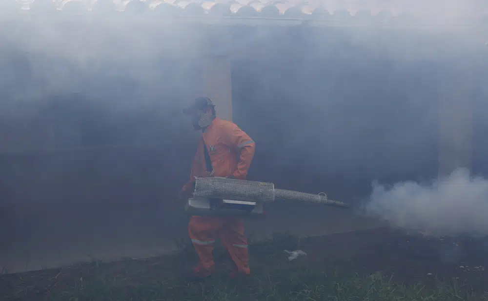 FILE - A city worker fumigates for Aedes aegypti mosquitoes inside a school in Santa Cruz, Bolivia, Thursday, Feb. 4, 2016. On Feb. 15, 2023, hospitals in this region of Bolivia struggled to keep up with an outbreak of dengue that has killed at least 26 people, the largest outbreak of the mosquito-borne disease since the COVID-19 pandemic. (AP Photo/Juan Karita, File)